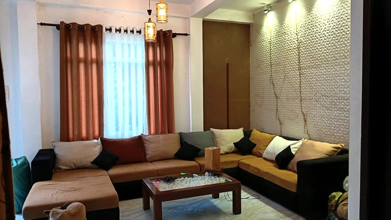 Living lounge with sectional sofas around a low wooden table